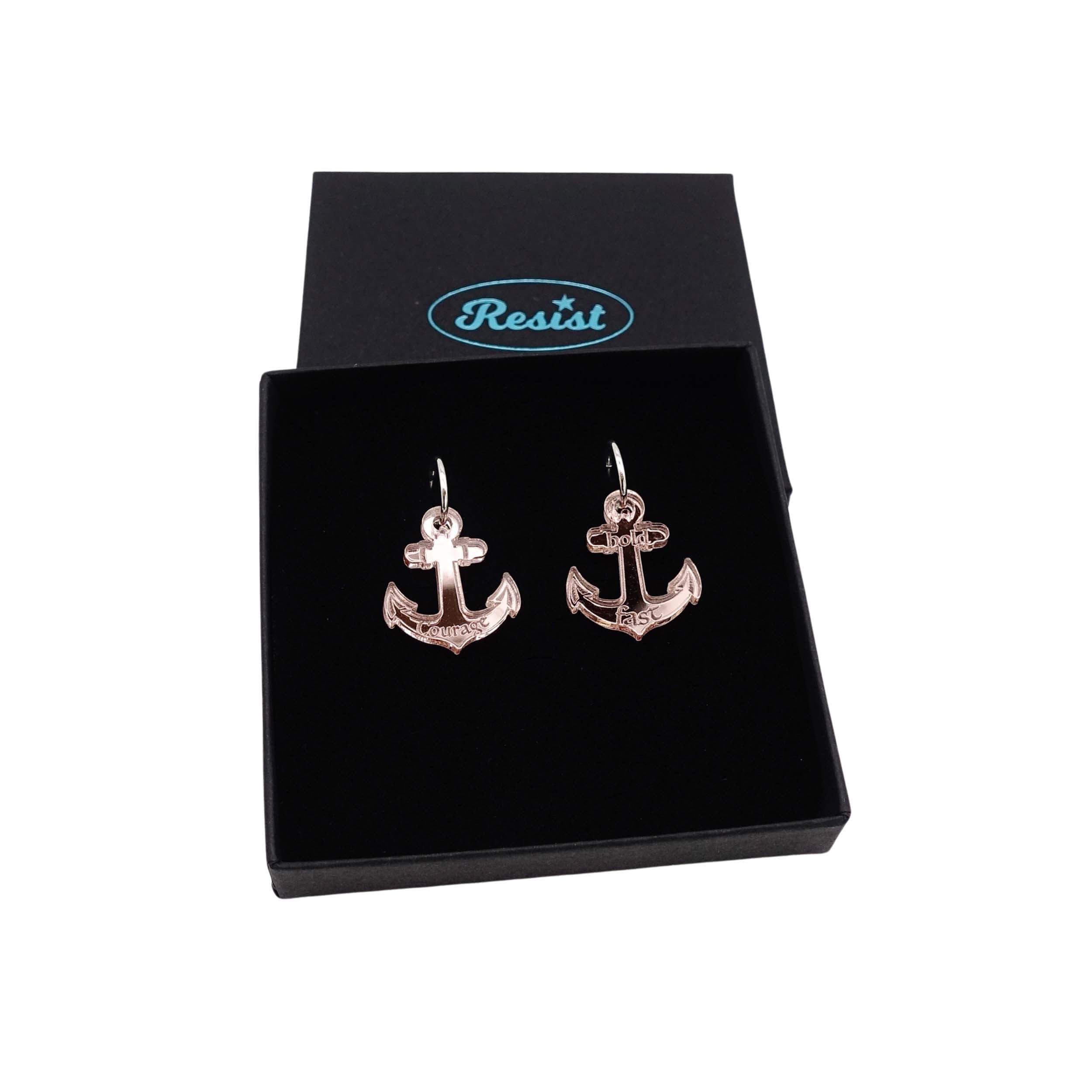 Medium anchor earrings in rose gold mirror etched with the words 'courage' on one and 'hold fast' on the other. Shown in a Wear and Resist gift box.