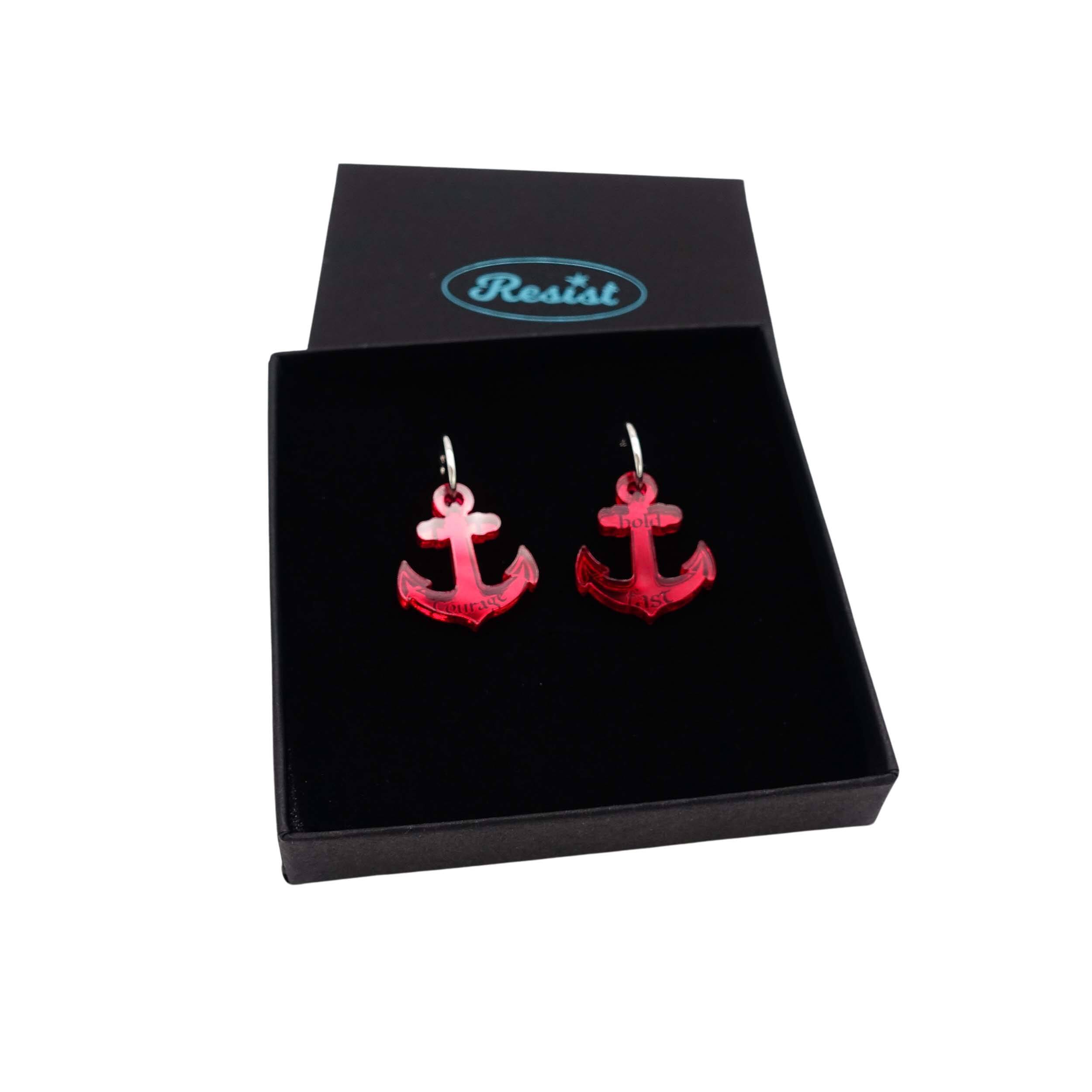 Medium anchor earrings in ruby mirror etched with the words 'courage' on one and 'hold fast' on the other. Shown in a Wear and Resist gift box.