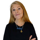 Sarah Day wears a Salty necklace with gold 'keep clear' anchor..