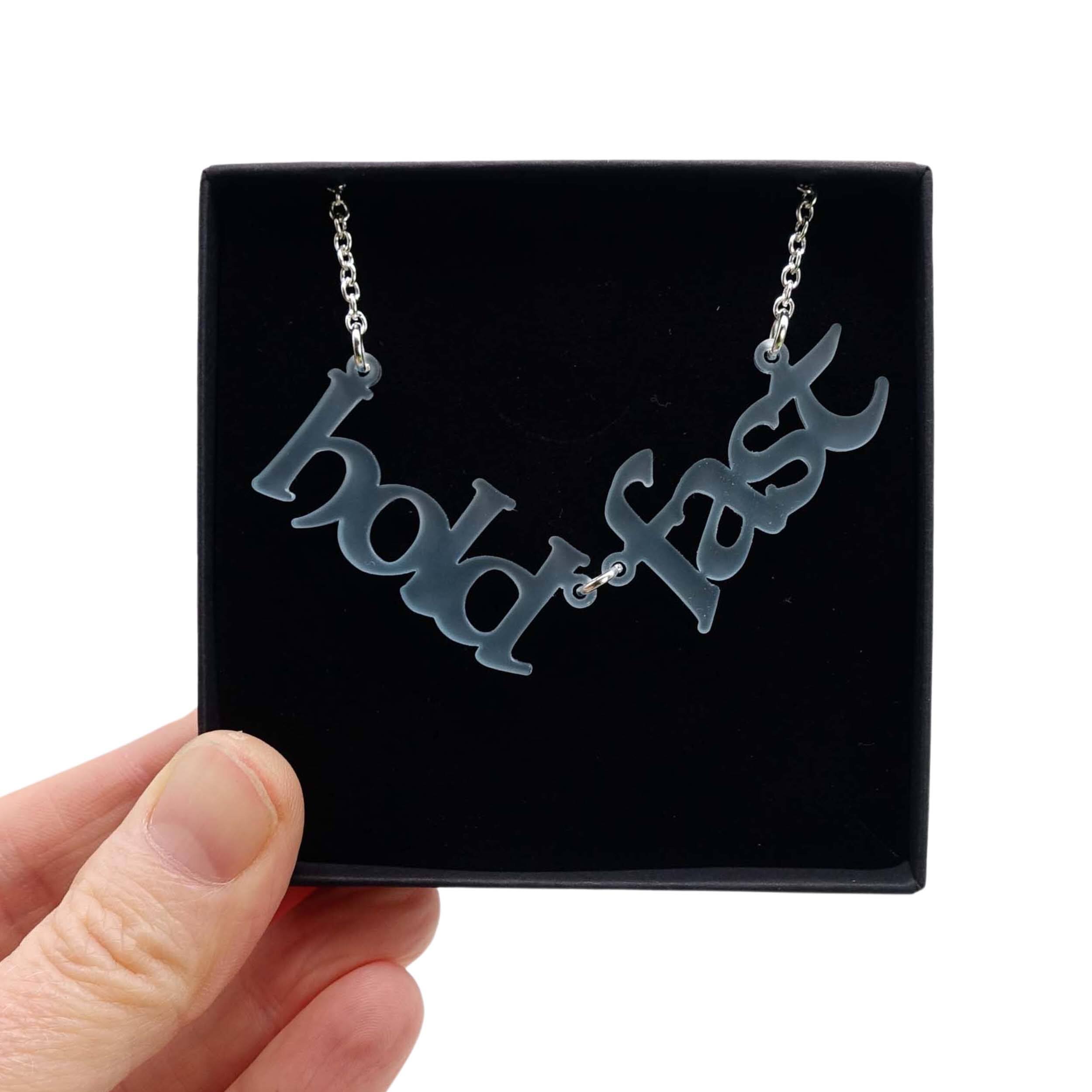 Hold Fast necklace in sea-foam shown held up in a Wear and Resist gift box.