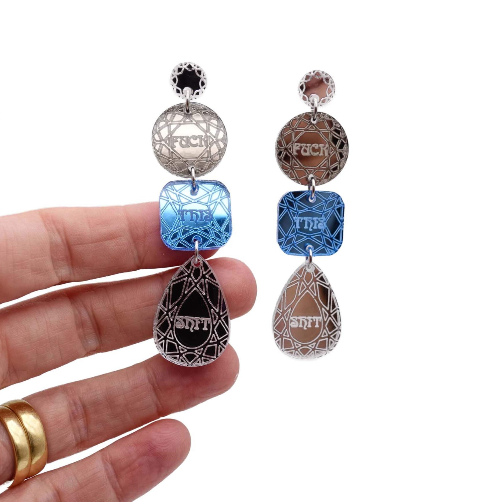 Sweary jewel drop earrings in bronze, sky and silver shown hanging against a white background.