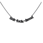Sh*t f*ck d*mn necklace in matte black shown hanging in front of a white background.
