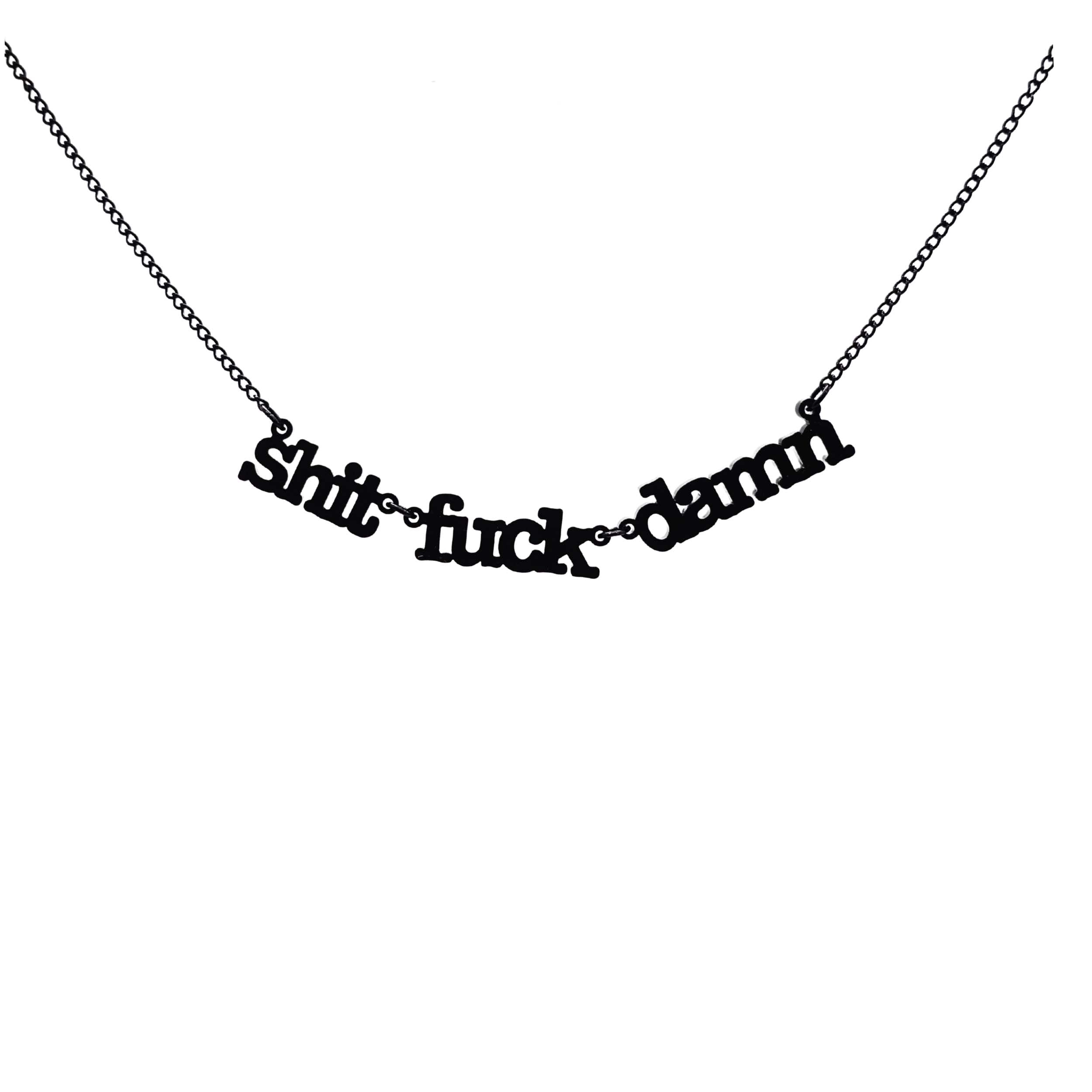 Sh*t f*ck d*mn necklace in matte black shown hanging in front of a white background.