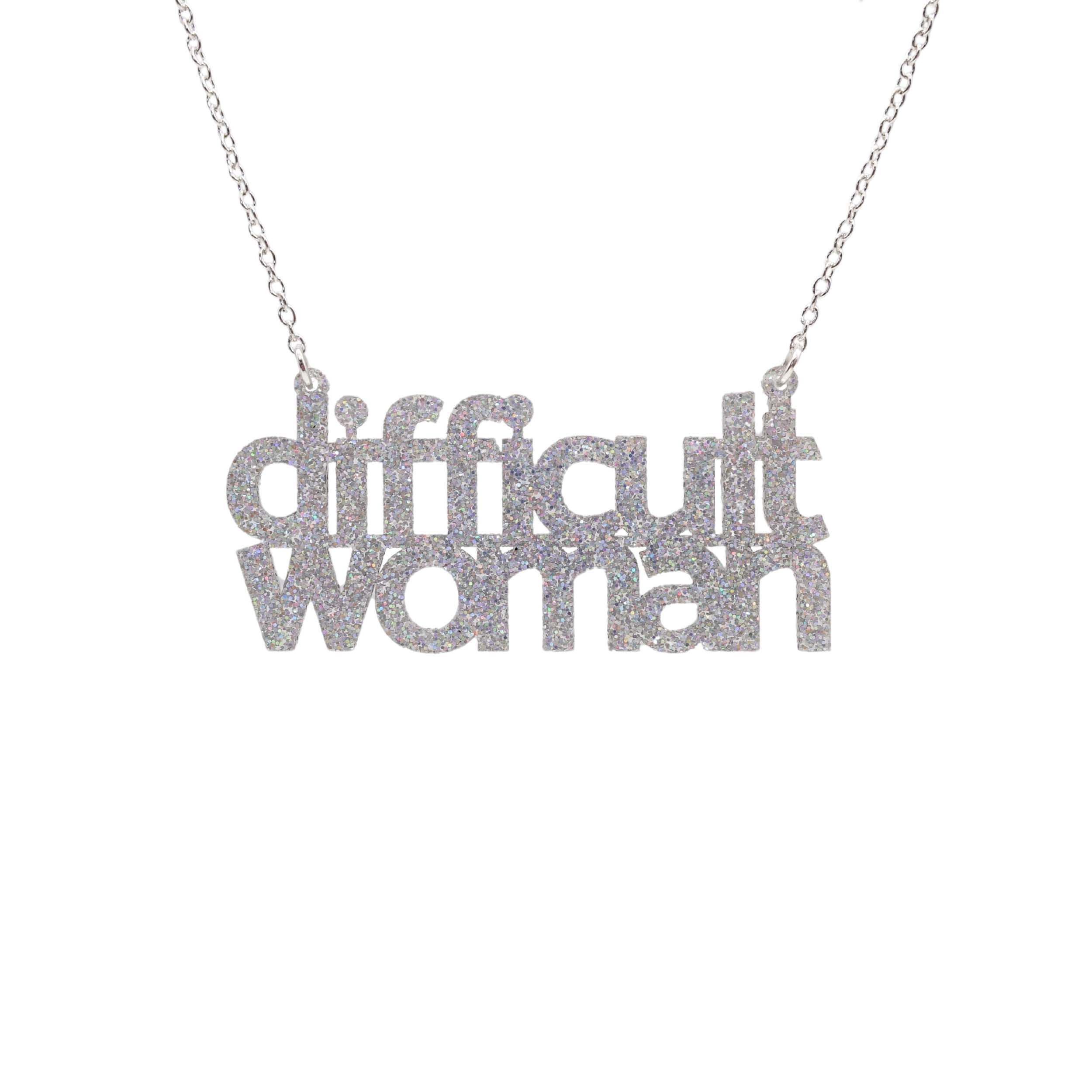 Difficult Woman necklace in silver glitter, shown hanging against a white background.