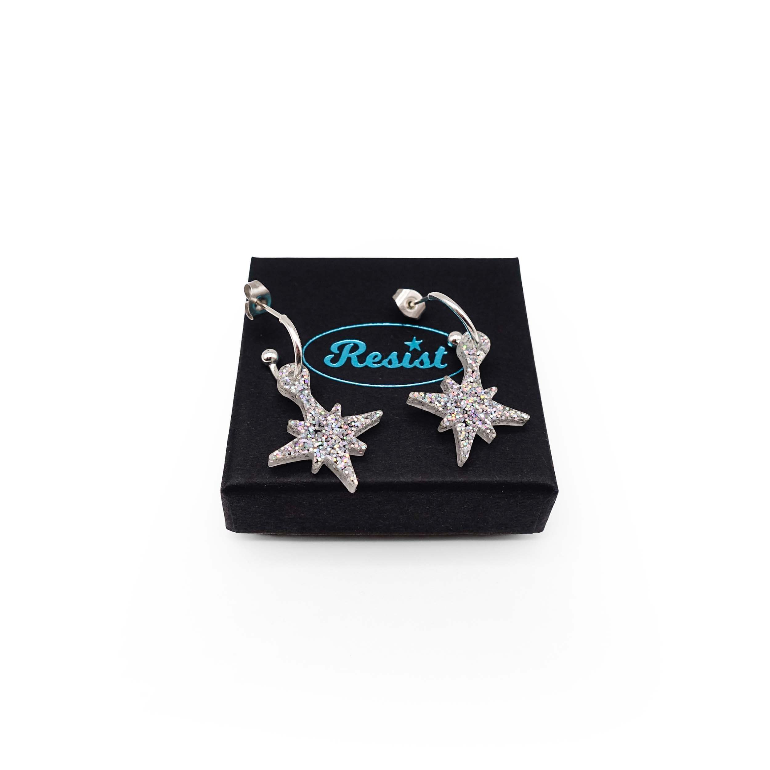 Silver glitter limited edition Festive Vintage Star earrings, shown on a Wear and Resist gift box.