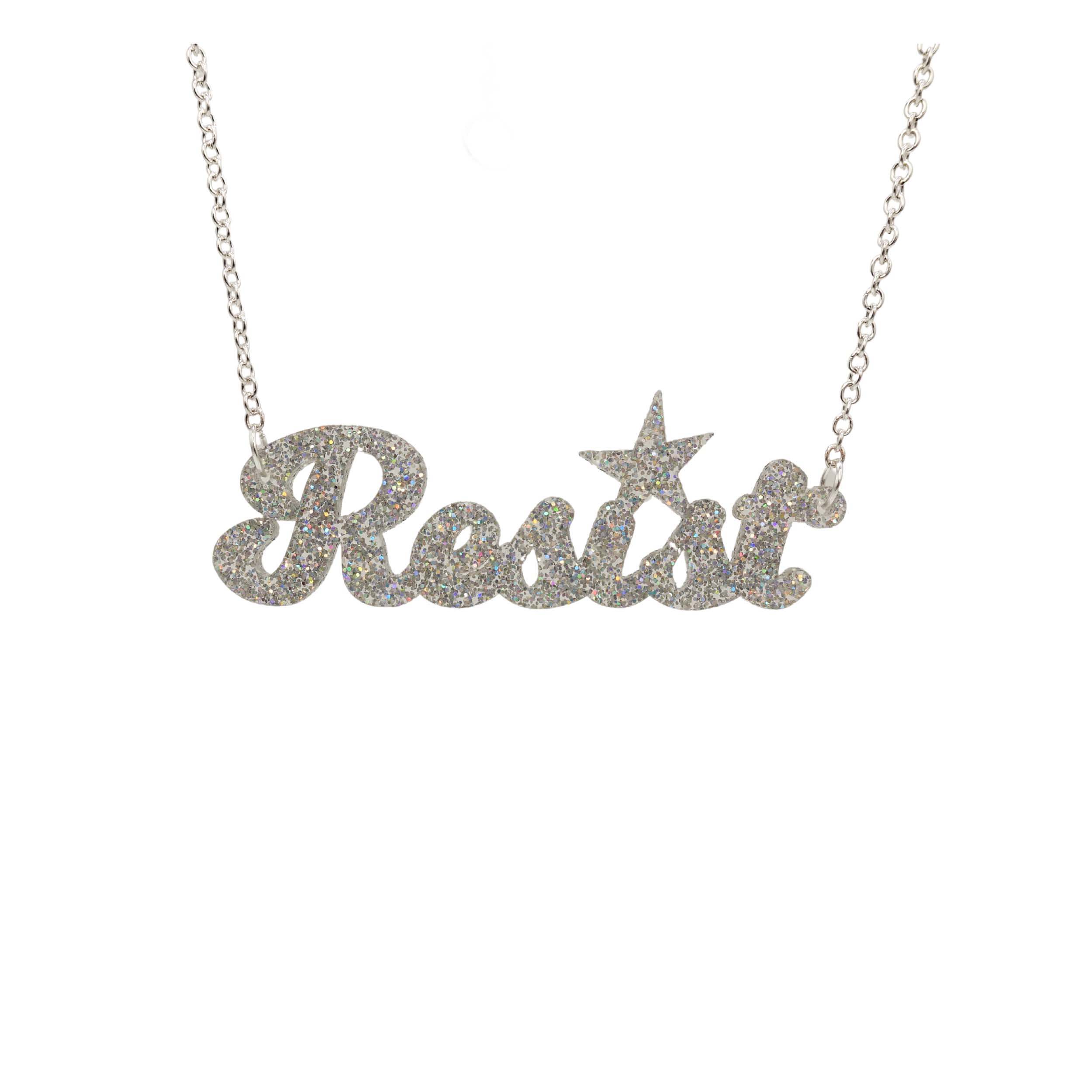 A 'Resist' necklace in silver glitter shown hanging against a white background.