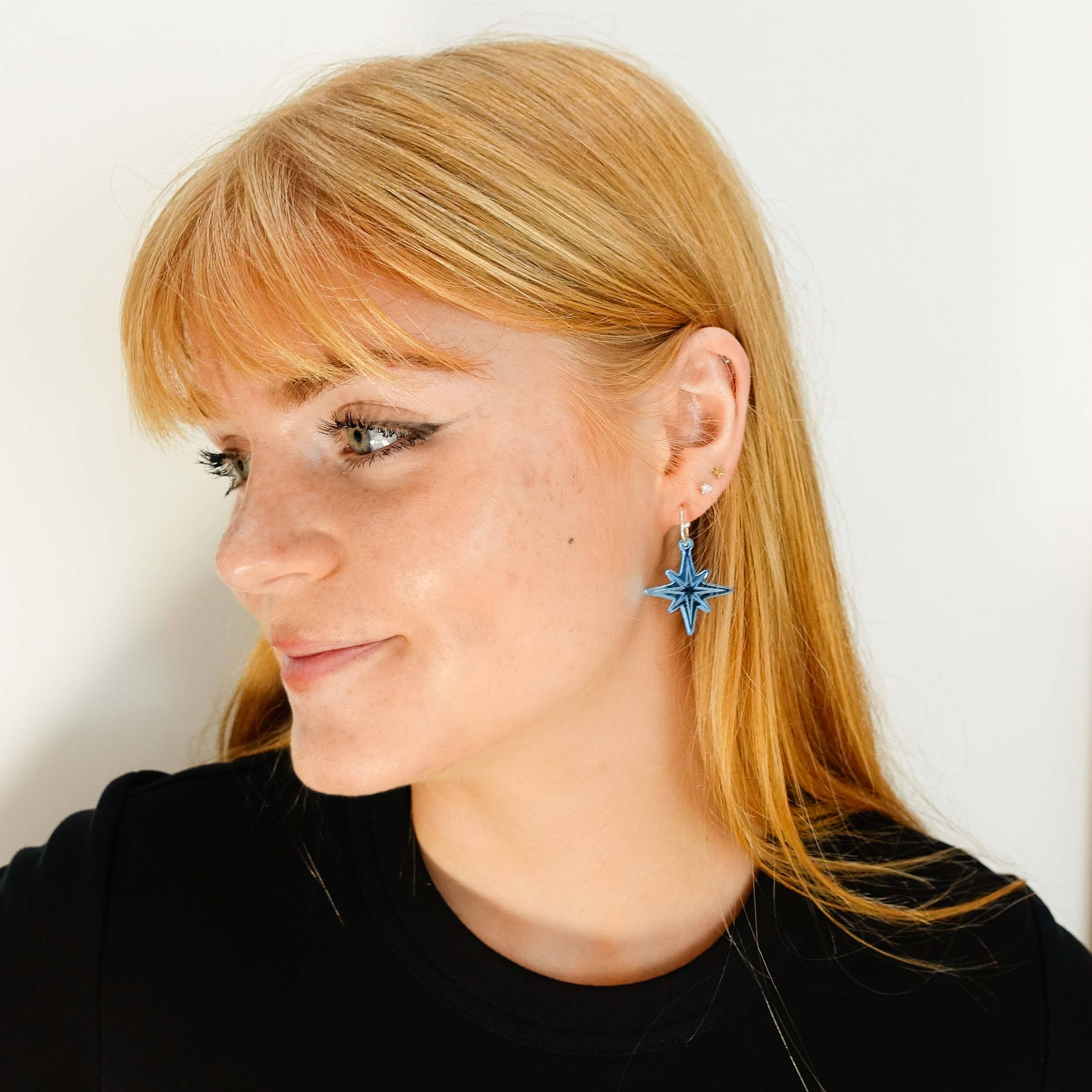 Eliza wears etched Vintage Star earrings in sky mirror from the Bronte Collection, designed by Sarah Day for Wear and Resist in collaboration with the Bronte Parsonage Museum.