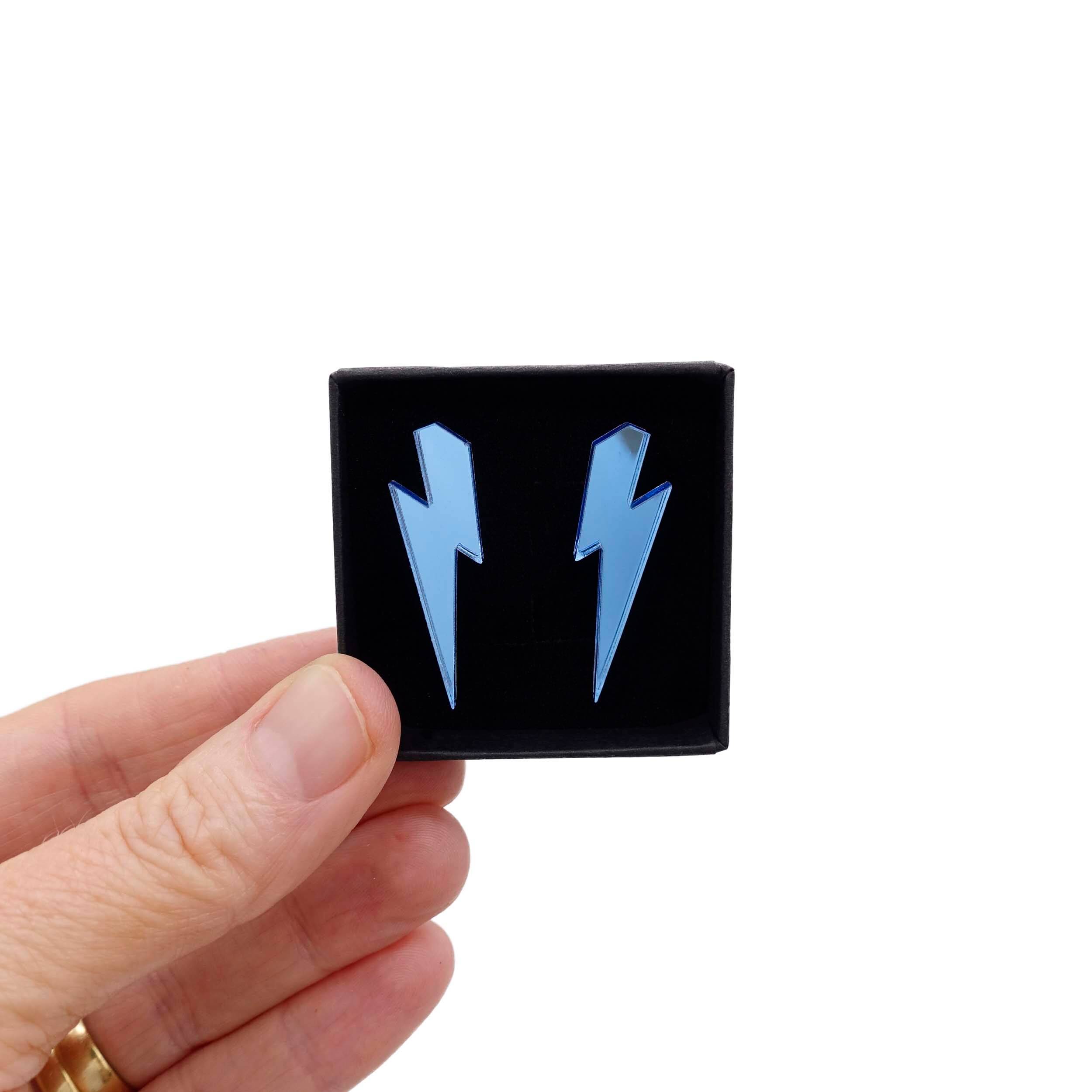 Medium Lightning Bolt earrings in sky mirror, shown held up in a small Wear and Resist gift box.