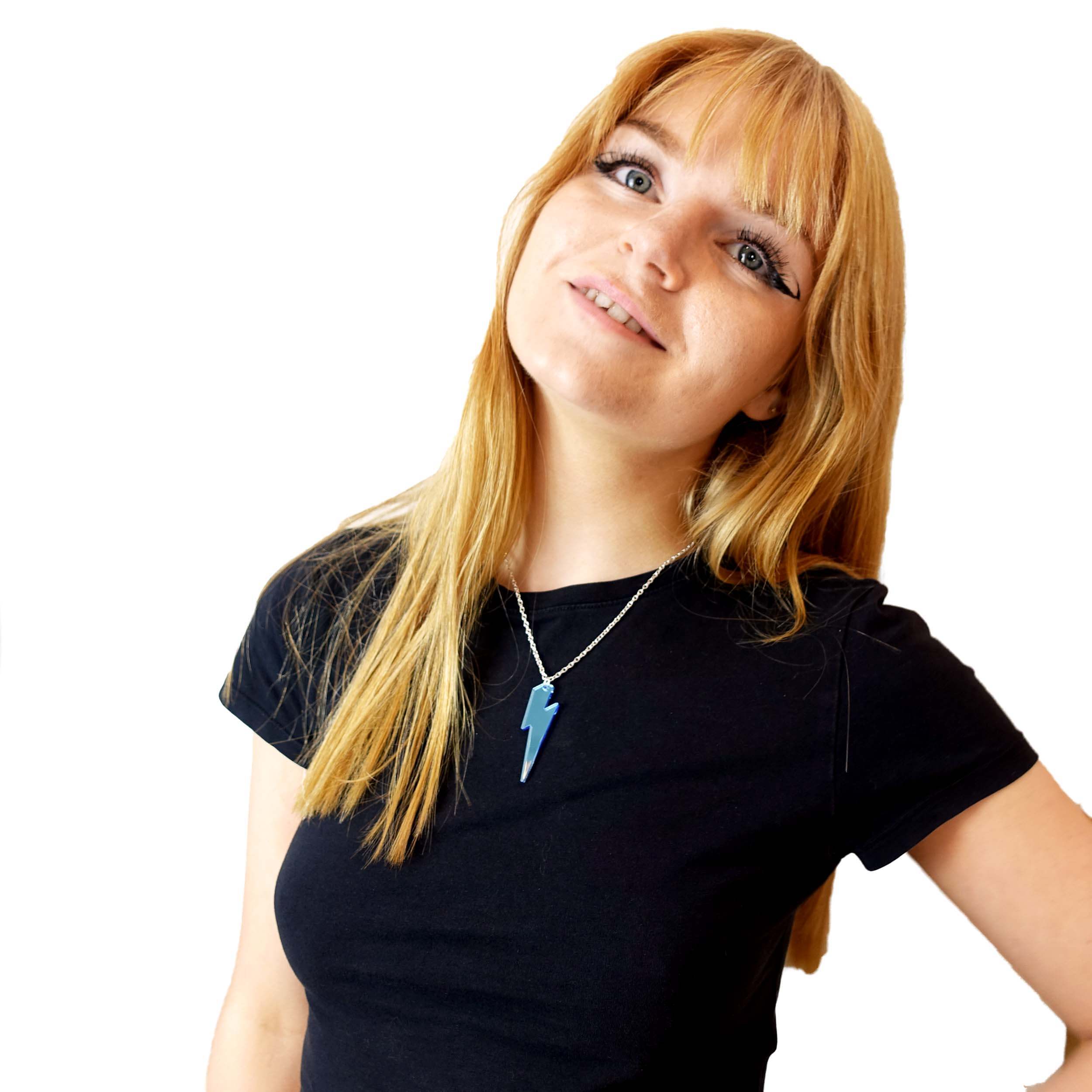 Eliza wears a sky mirror Lightning Bolt pendant.