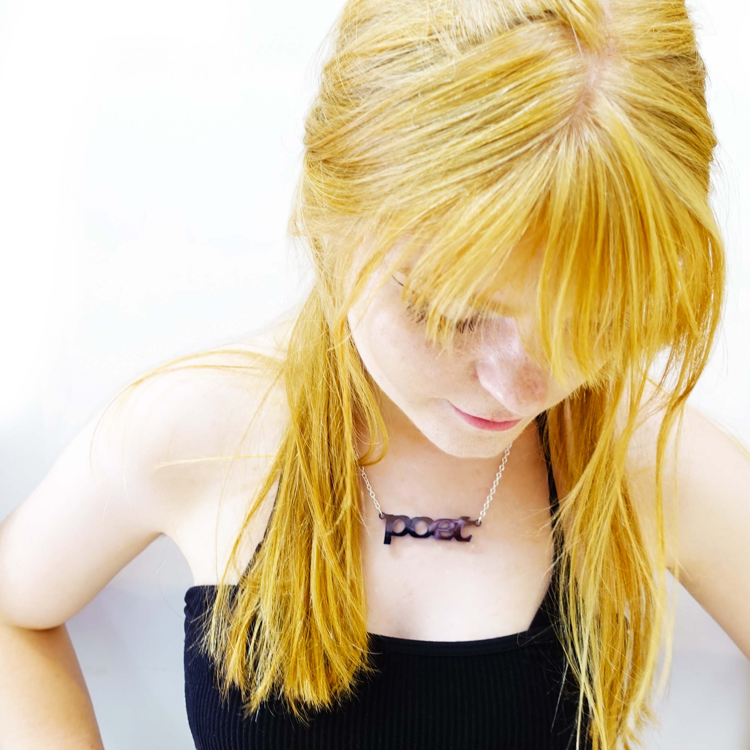 Eliza wears a slate mirror poet necklace designed by Sarah Day for Wear and Resist.