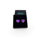 Purple heart stud earrings shown in a Wear and Resist gift box.
