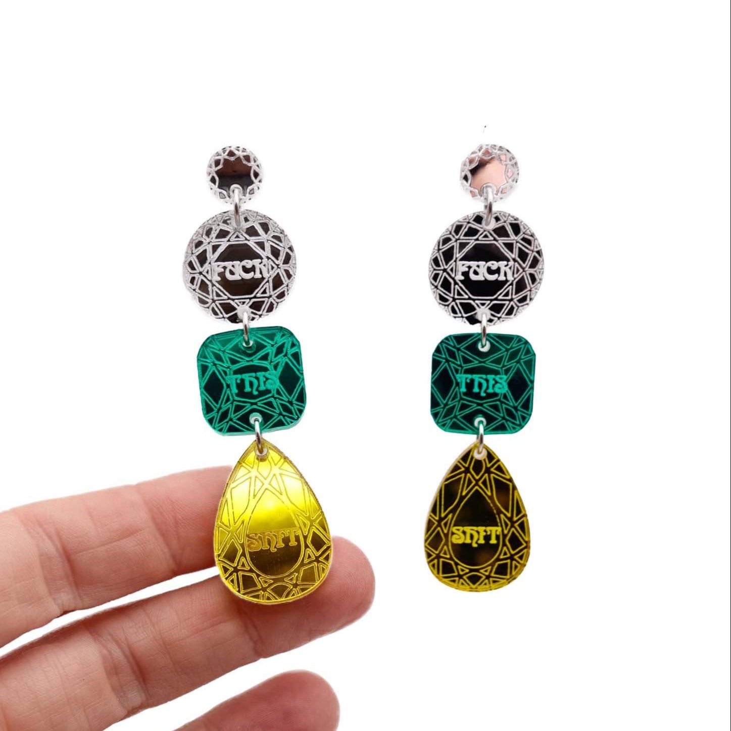 Sweary jewel drop earrings in silver, green and yellow shown hanging with my hand behind to show the reflective quality of the mirror acrylic.