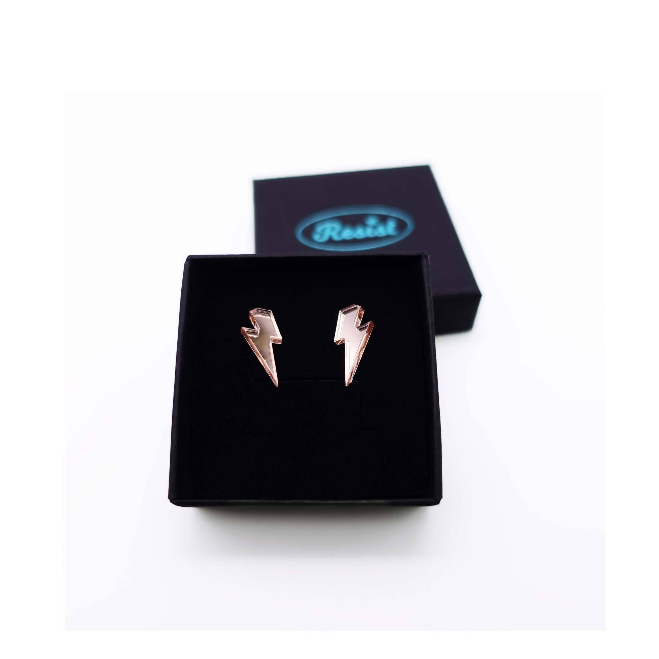 Tiny Lightning Bolt earrings in rose gold mirror, shown in a small Wear and Resist gift box.