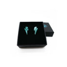 Tiny Lightning Bolt earrings in teal glitter, shown in a Wear and Resist gift box.