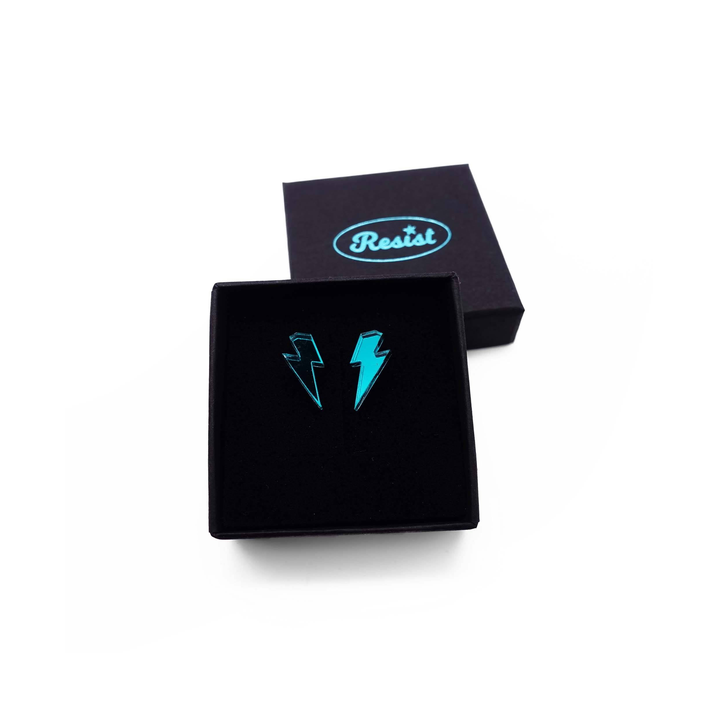 Tiny Lightning Bolt earrings in teal mirror, shown in a small Wear and Resist gift box.