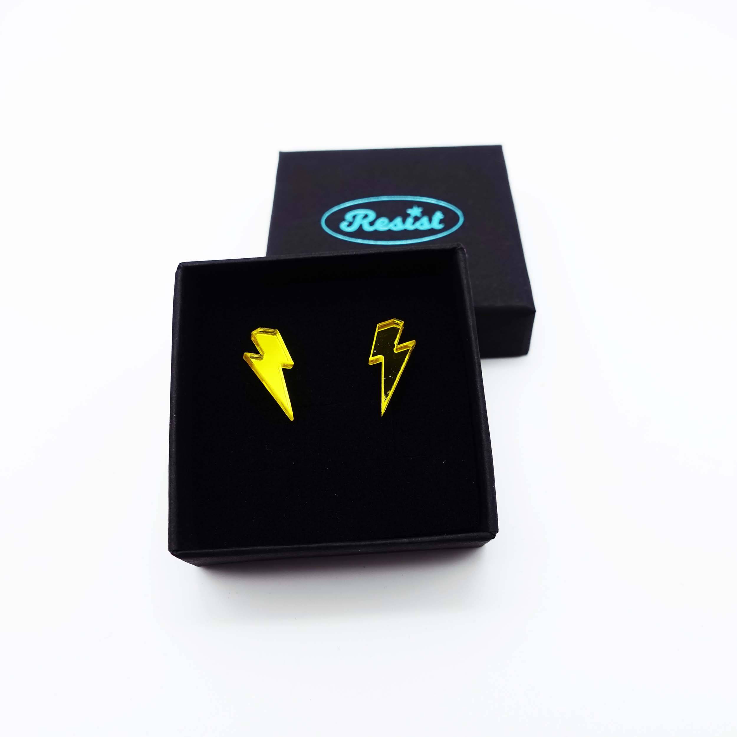 Tiny Lightning Bolt earrings in yellow mirror, shown in a small Wear and Resist gift box.