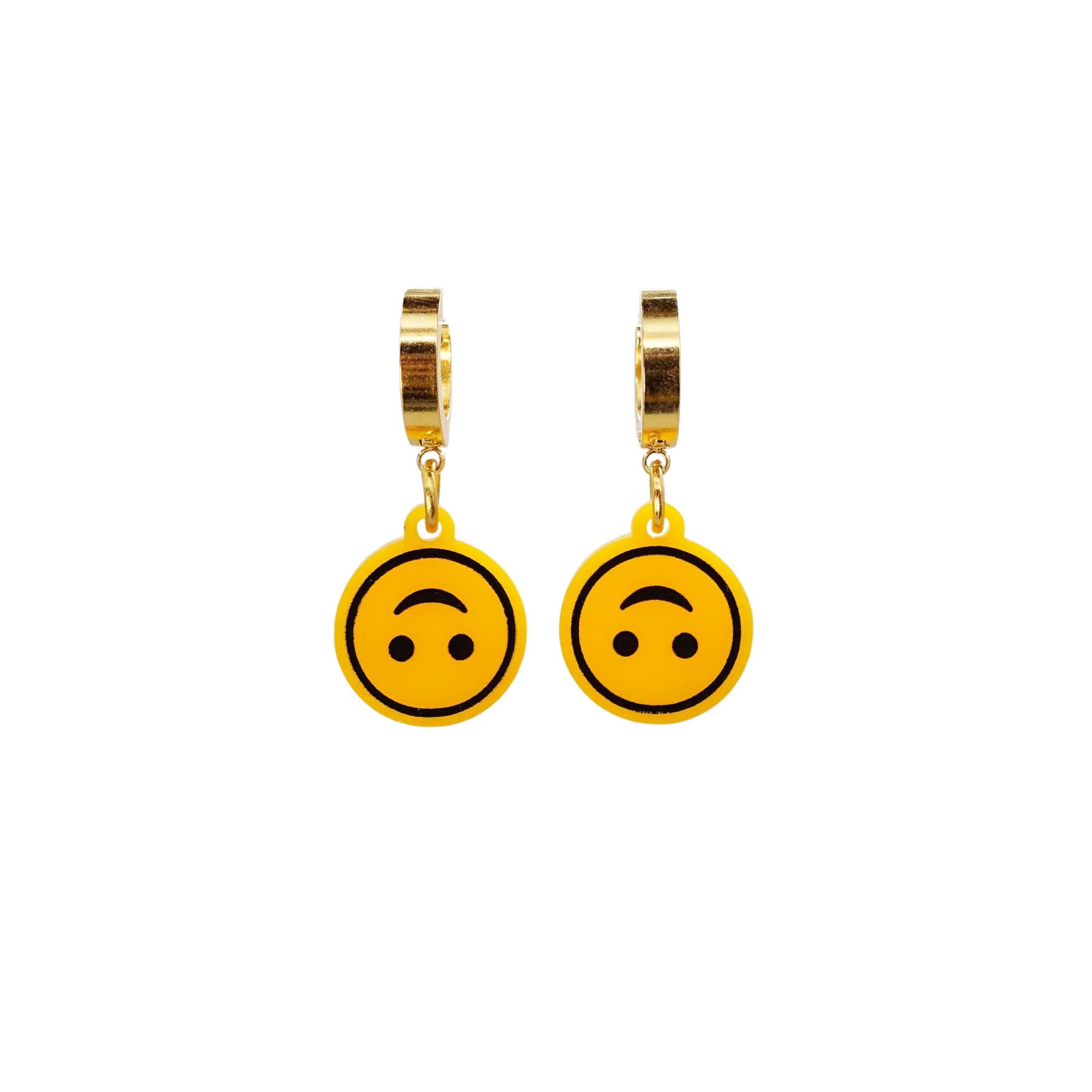 Upside-down smiley face earrings on gold huggie hoops, shown hanging against a white background.