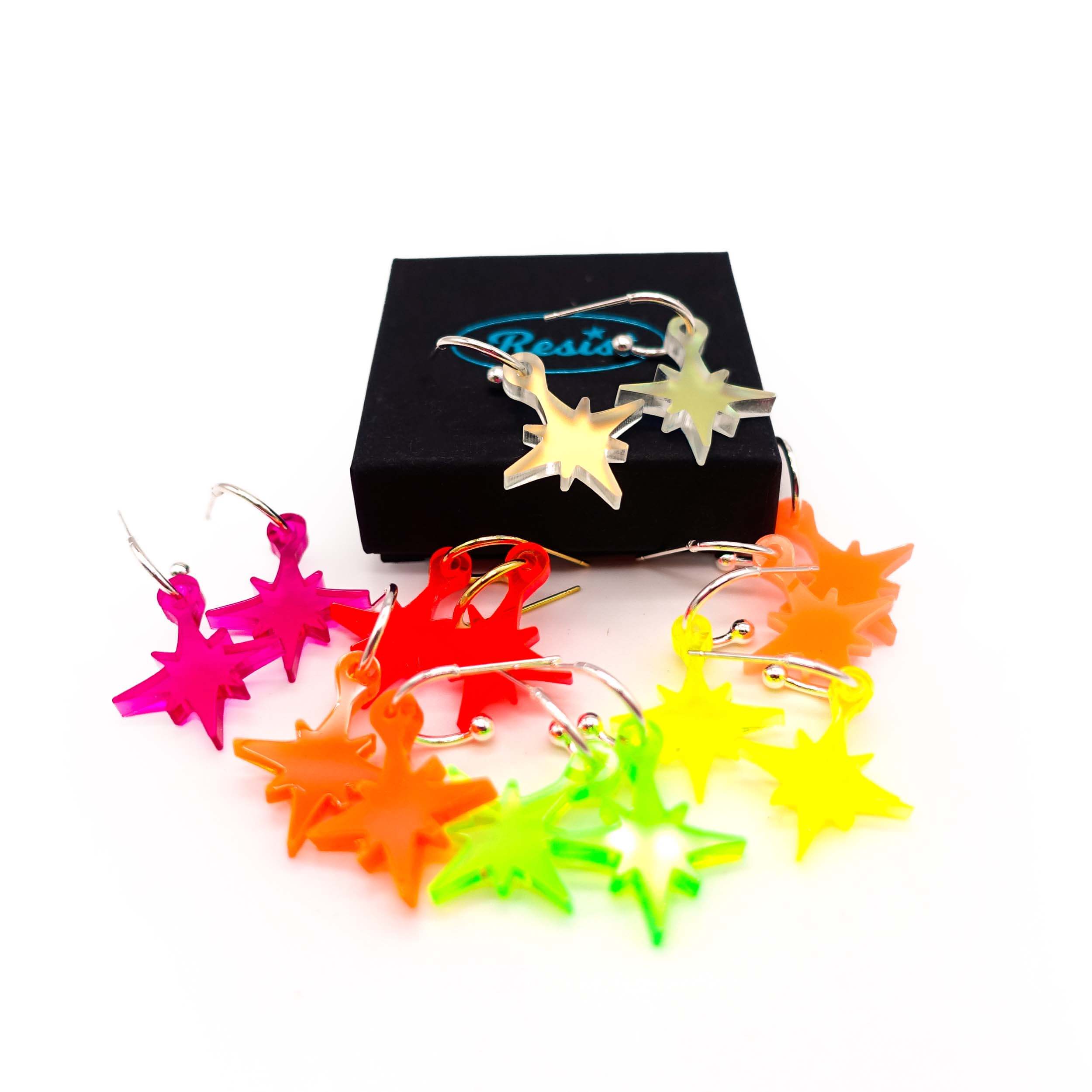A group shot of the neon vintage star earrings shown with a small Wear and Resist gift box.