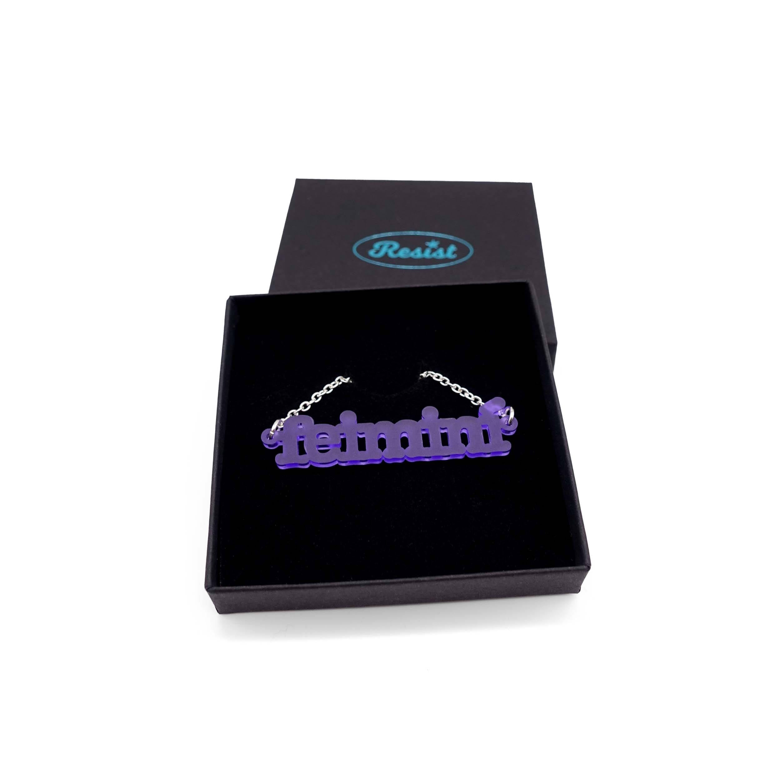 Irish Gaelic Feiminí necklace in violet frost, shown in a Wear and Resist gift box.