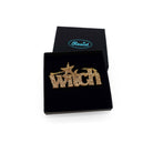 Gold glitter Witch necklace shown in a Wear and Resist gift box.