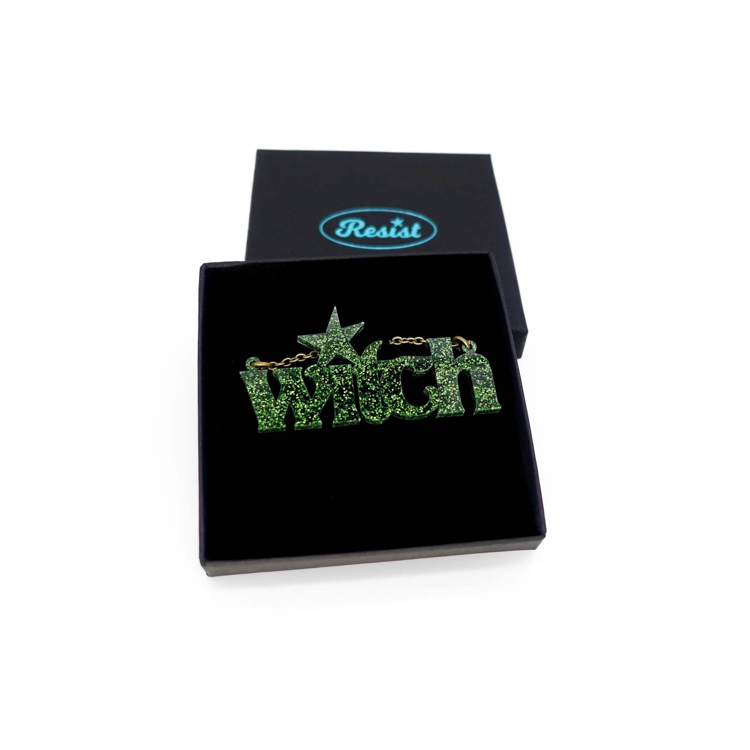 Moss glitter Witch necklace shown in a Wear and Resist gift box.
