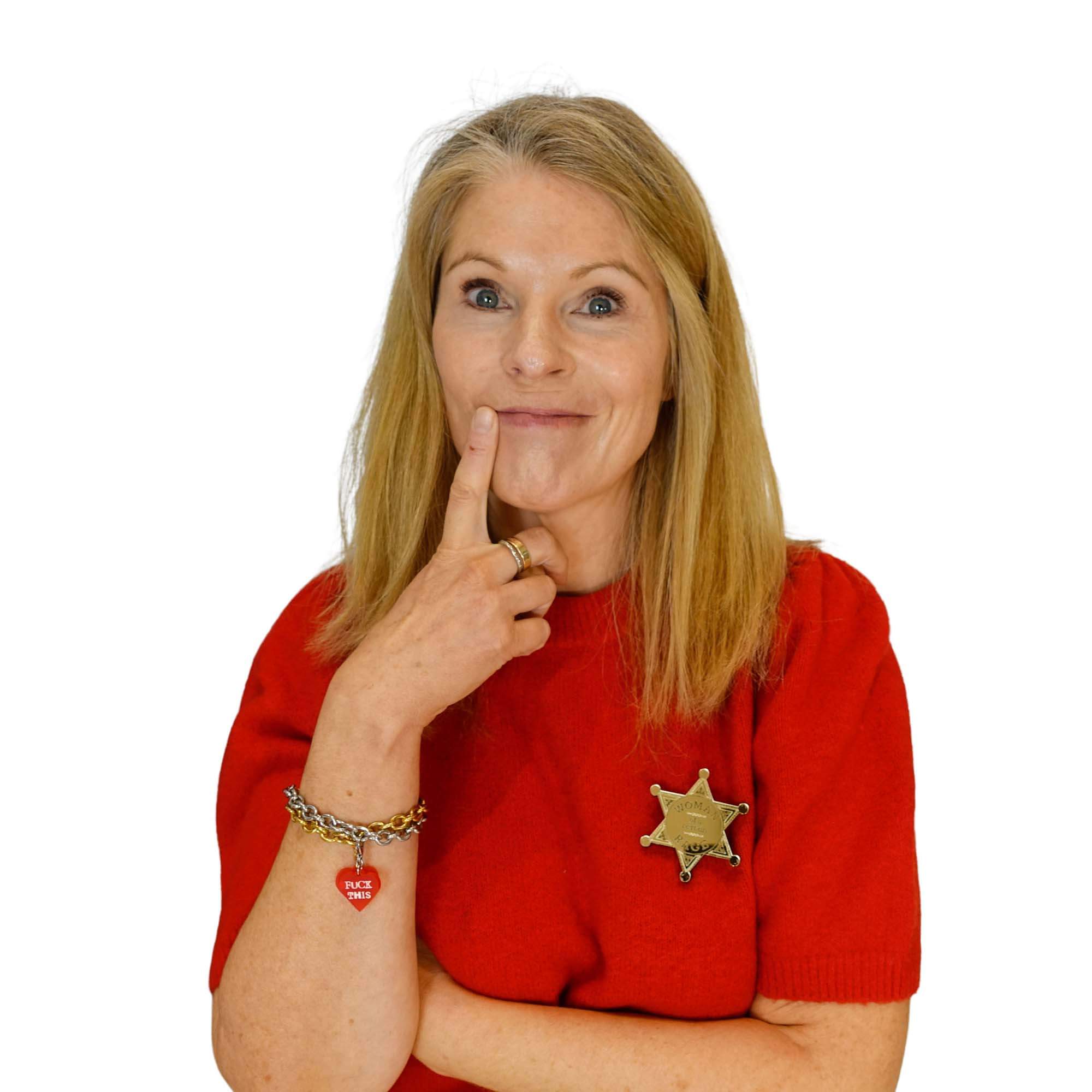Sarah wears a gold Woman of  Certain Rage sheriff badge.