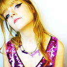 Eliza wears a F*ck these F*cking F*ckers necklace in purple mirror,  by Wear and Resist, and a very pretty pink sequin dress.