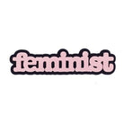 Feminist brooch in baby pink.
