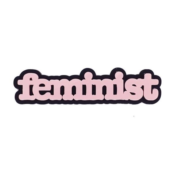 Feminist brooch in baby pink.