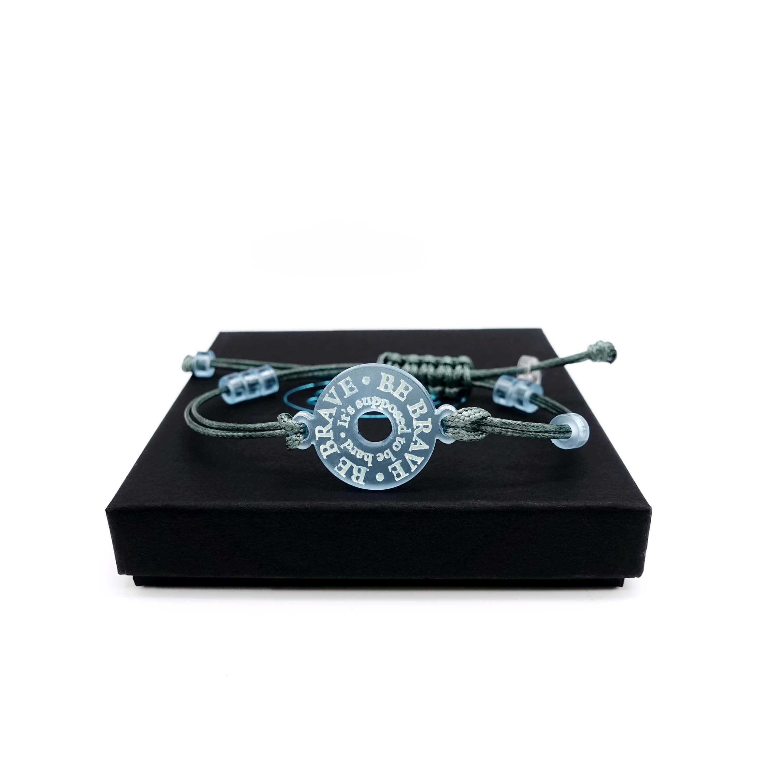 Be Brave friendship bracelet shown on a Wear and Resist gift box.