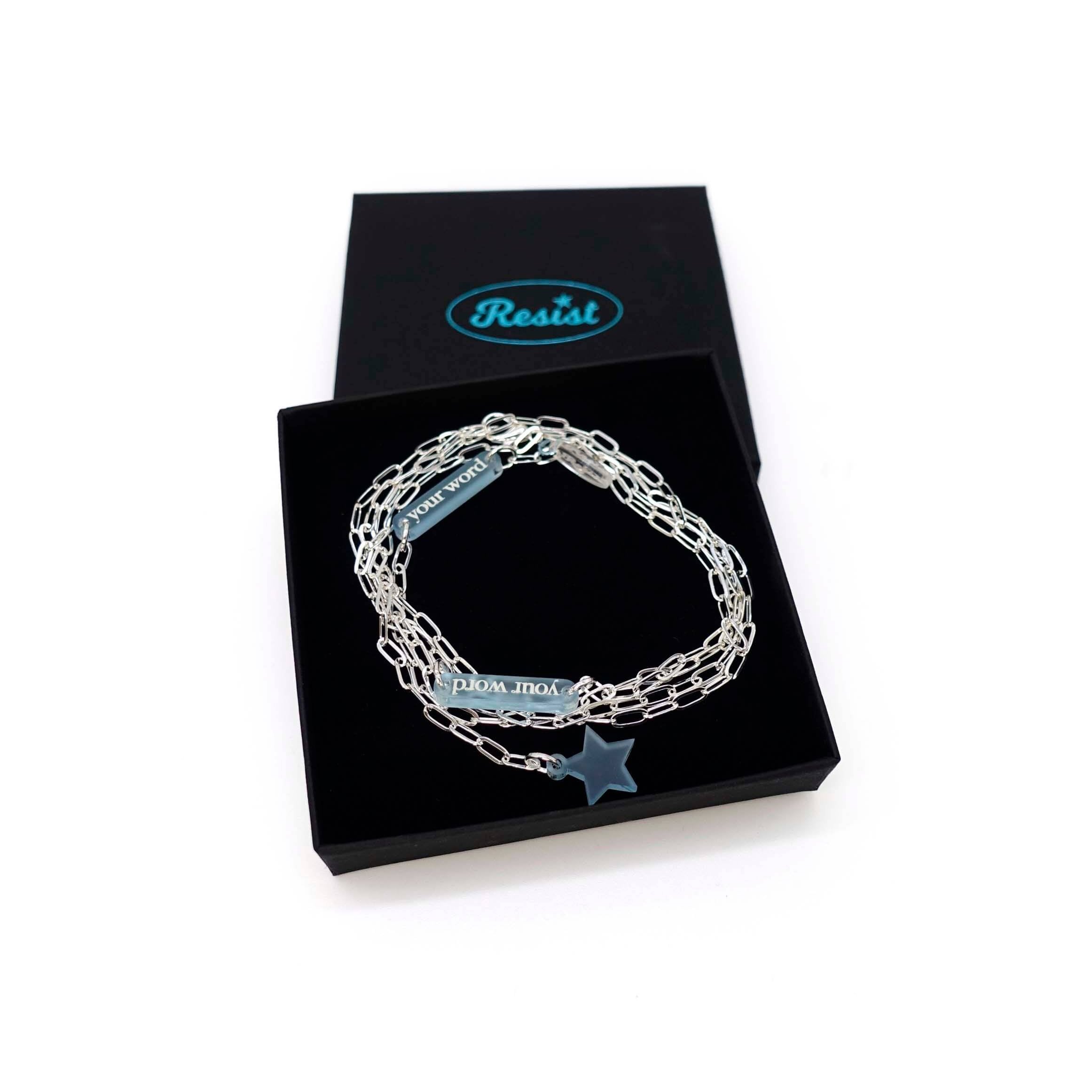 The Have a Word with Yourself design on a silver-plated paperclip chain, with any two combinations of your own words etched in glow-in-the-dark pigment and finished with a charm of your choice, shown here with a star in a Wear and Resist gift box.