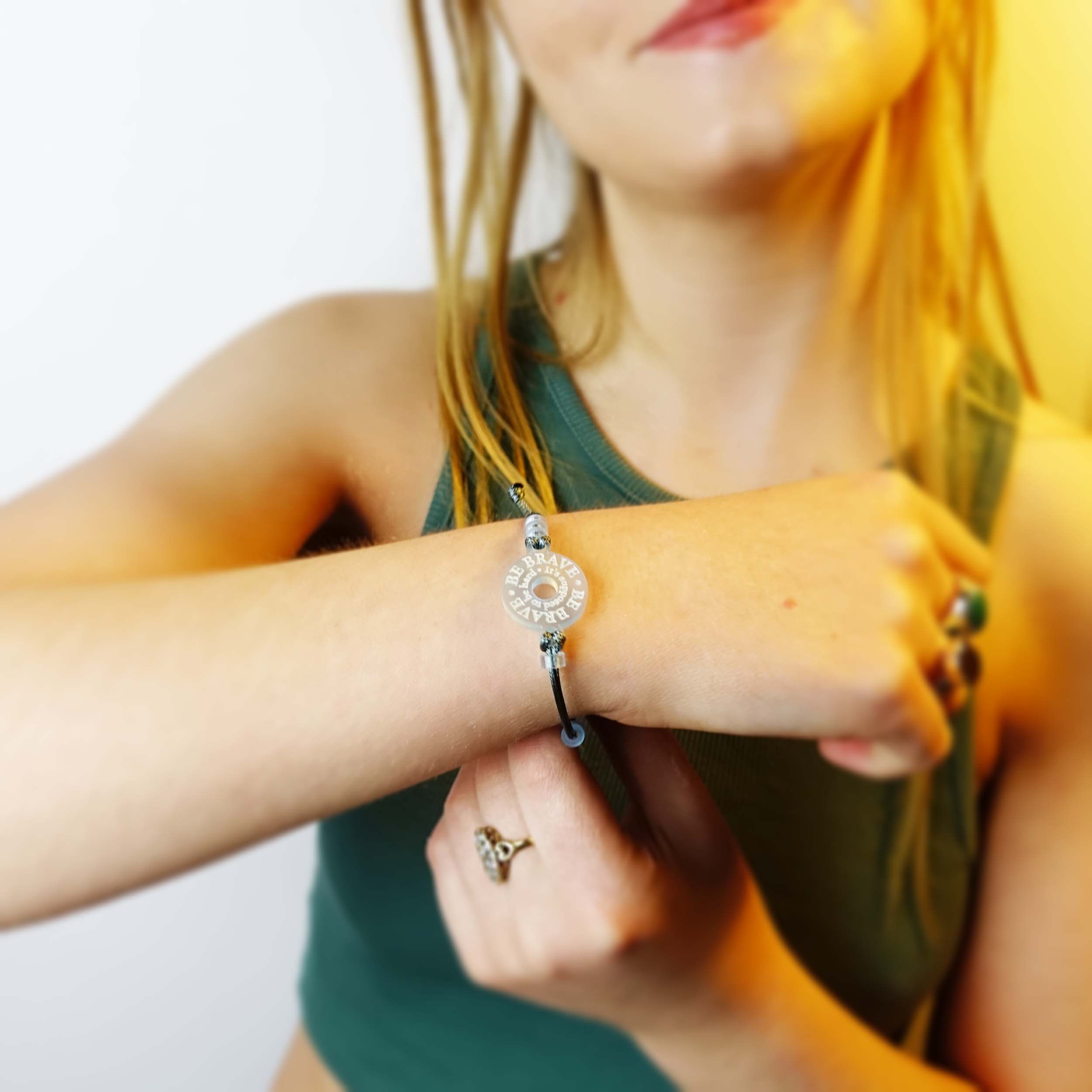 Eliza wears Wear and Resist's Be Brave bracelet.
