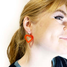 Eliza wears big hot red love heart hoops designed by Sarah Day for Wear and Resist.