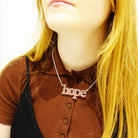 Eliza wears blush frost Hope necklace. Give someone the gift of hope.