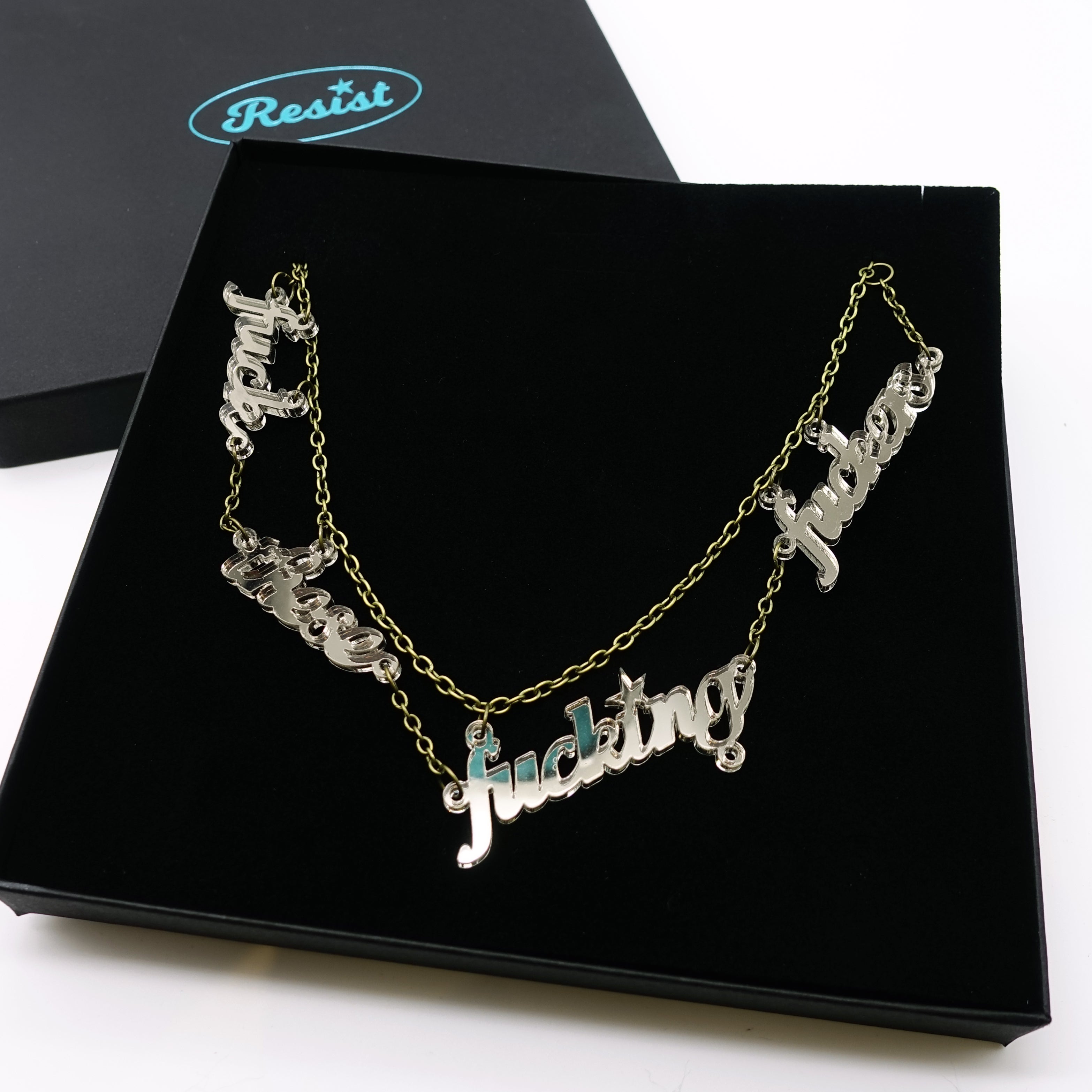 F*ck these F*cking F*ckers necklace in bronze mirror, shown in a large Wear and Resist gift box.