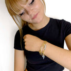 Eliza wears the Have a Word with Yourself design on a gold-plated paperclip chain as a bracelet with the words 'persist' and 'be brave' etched in glow-in-the-dark pigment finished with a small lightning bolt charm.
