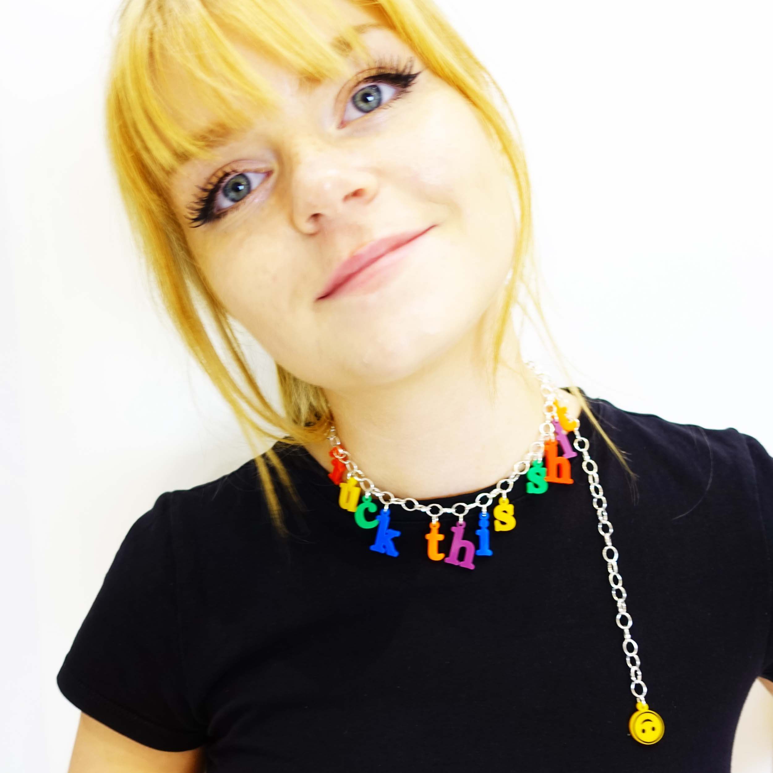 Eliza wears the F*ck this Sh*t necklace in retro alphabet font inspired by childhood fridge letters, as a choker, finished with an upside down smiley face.