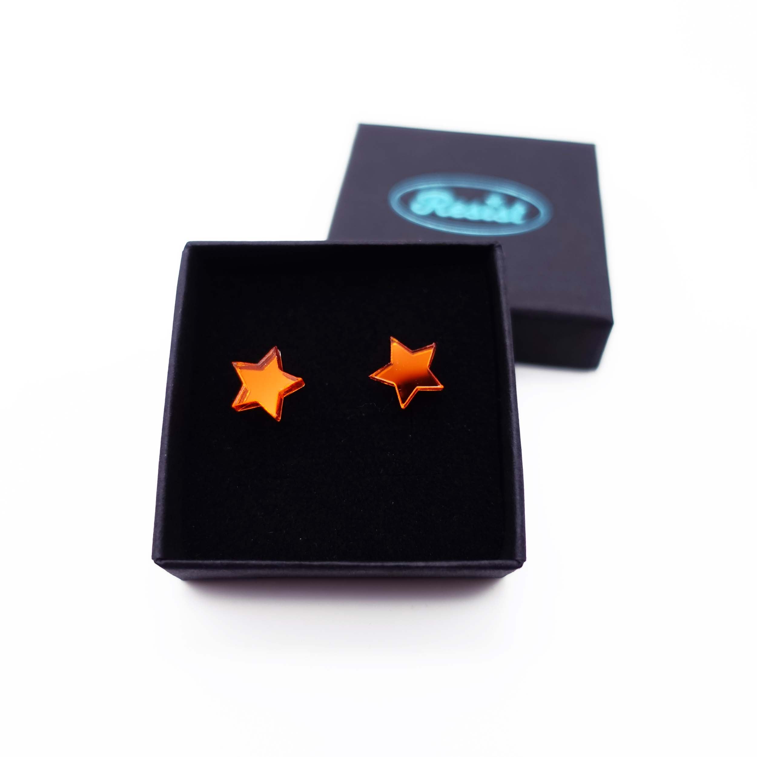 Flame mirror star stud earrings shown in box.