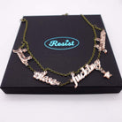 F*ck these F*cking F*ckers necklace in rose gold mirror, shown on top of a large Wear and Resist gift box.