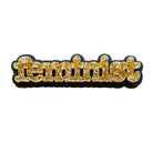 Feminist brooch in gold glitter.