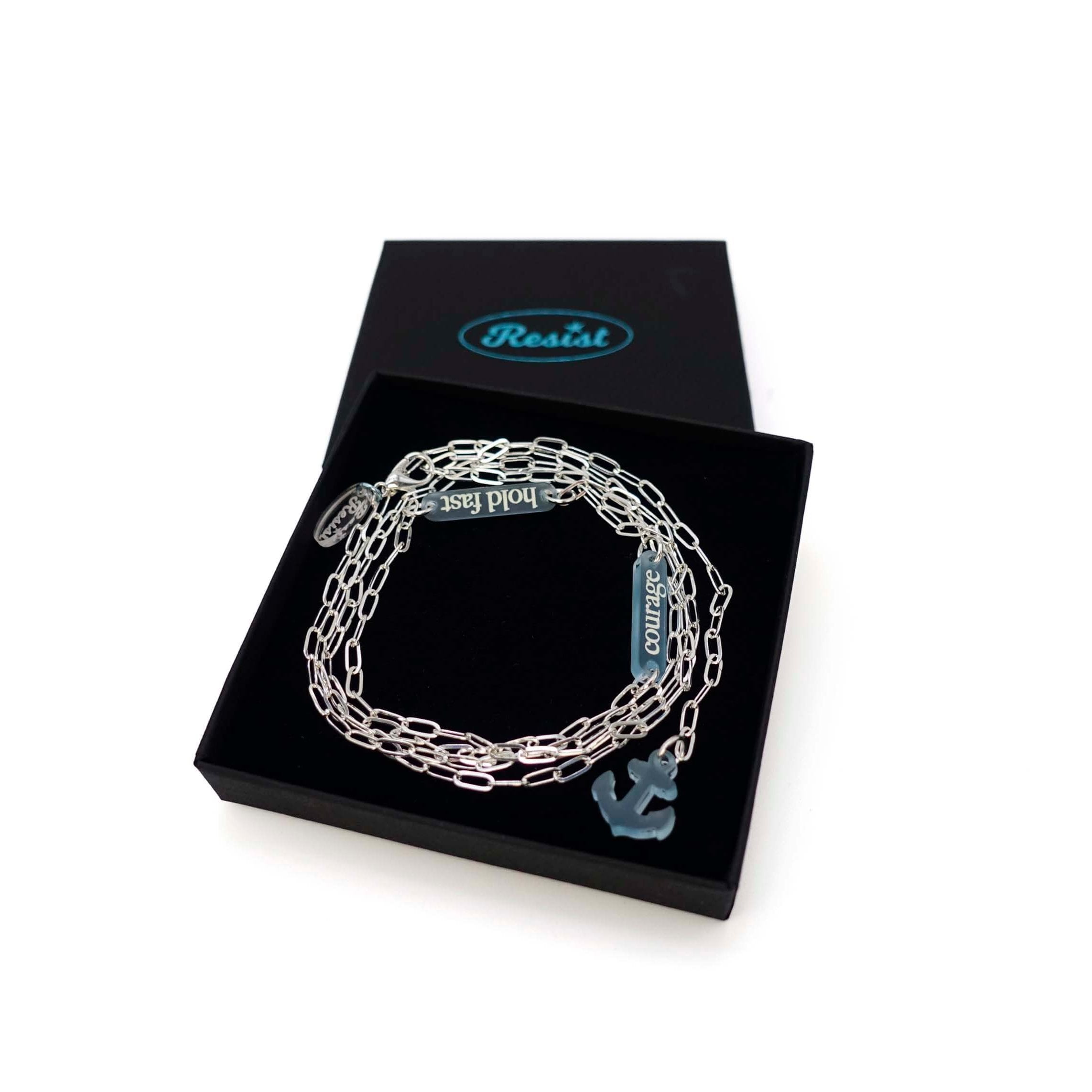 The Have a Word with Yourself design on a silver-plated paperclip chain, with the words 'courage' and 'hold fast' etched in glow-in-the-dark pigment and finished with an anchor charm. Shown in a Wear and Resist gift box.