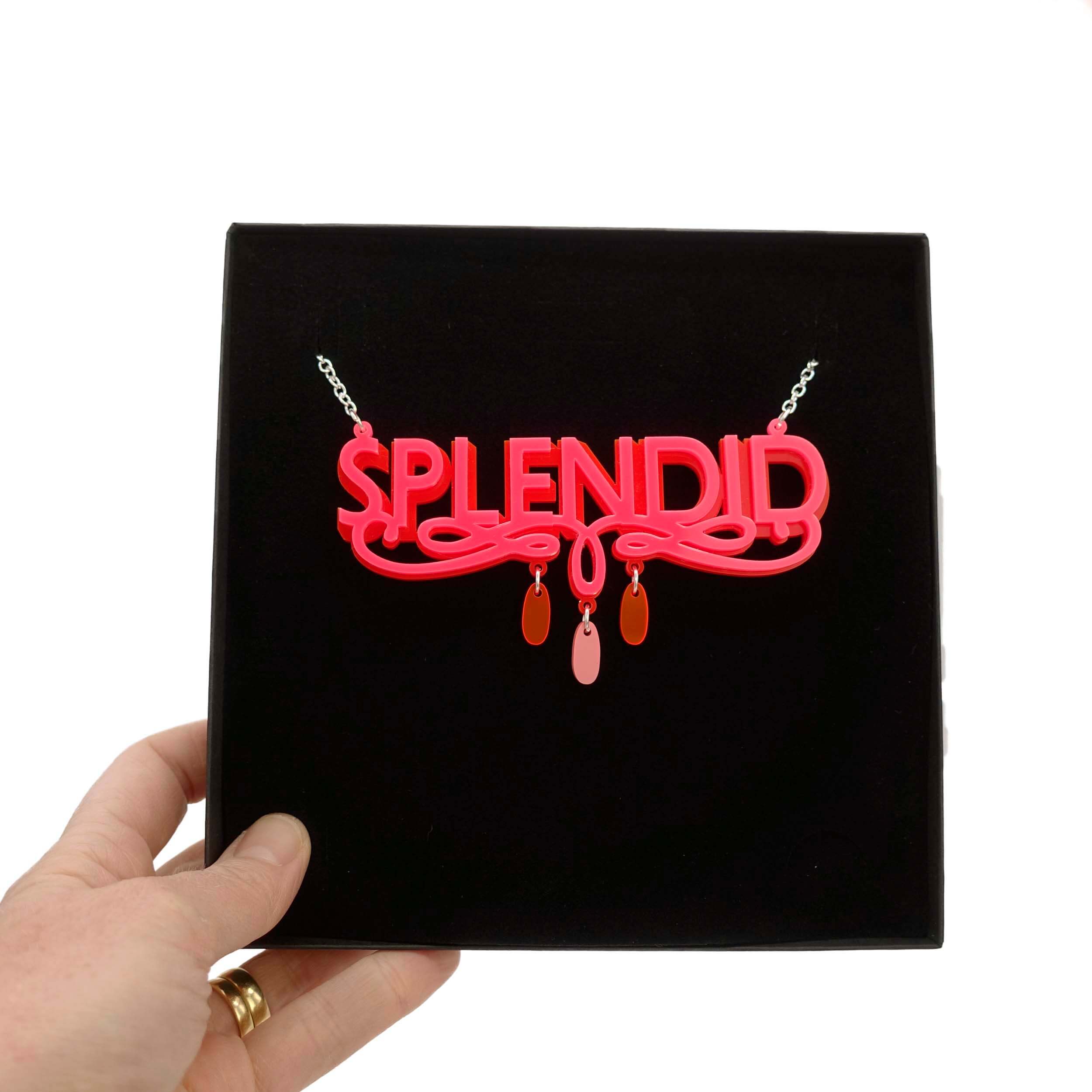 Hot pink and red Splendid necklace shown in a Wear and Resist gift box.