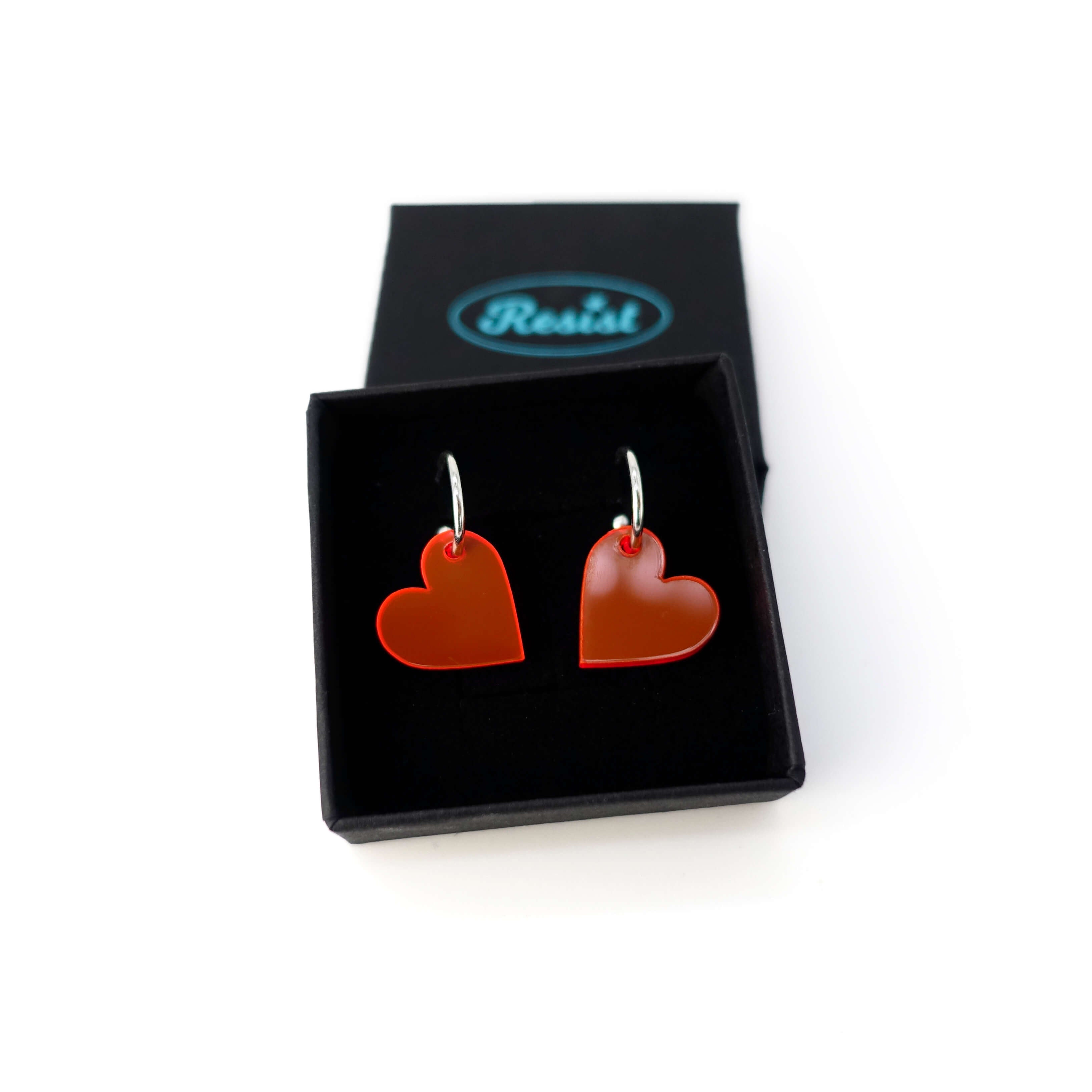 Hot red simple heart hoop earrings on silver-plated hoops. Shown in a Wear and Resist gift box.