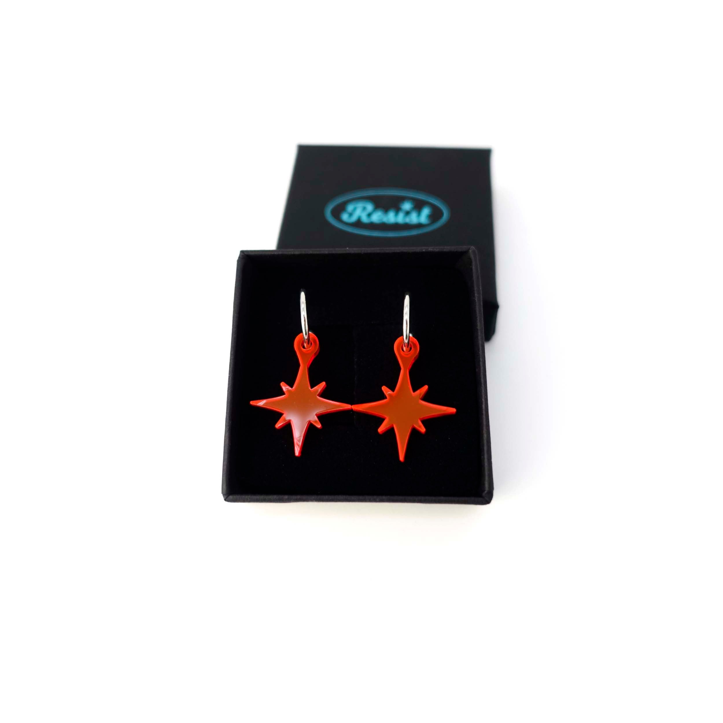 Hot red vintage star earrings shown in a Wear and Resist gift box.