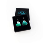 Iridescent simple heart hoop earrings on silver-plated hoops. Shown in a small Wear and Resist gift box.