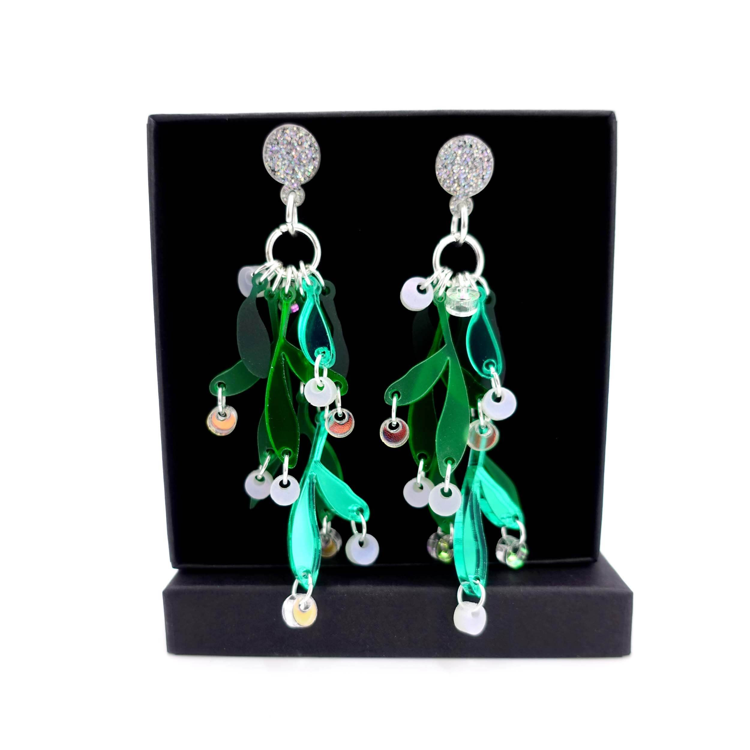 Mistletoe earrings designed by Sarah Day shown against a Wear and resist gift box.