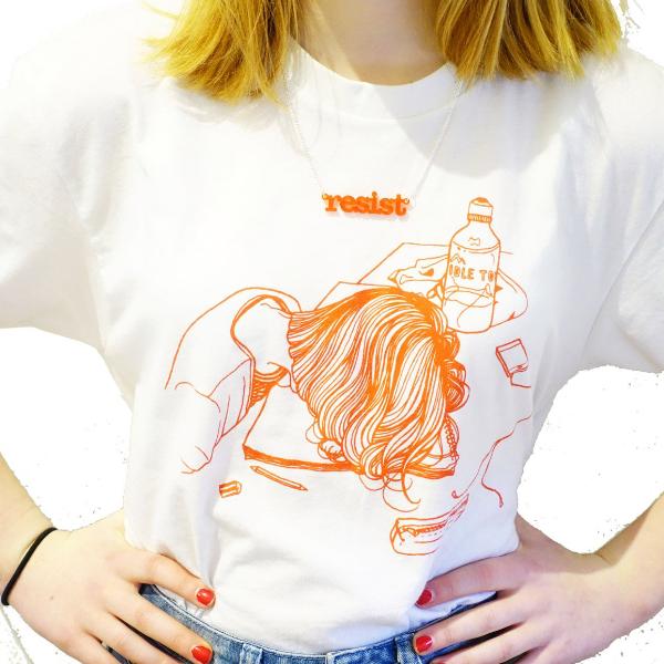 Eliza wears a chilli red frost typewriter font resist necklace, the first necklace Sarah Day designed when founding Wear and Resist!