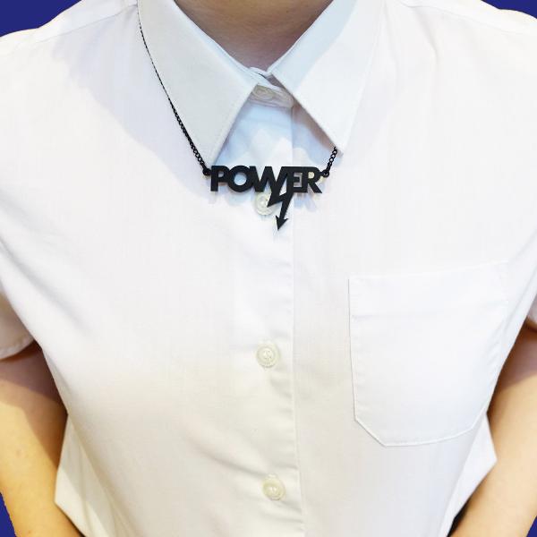 Model wears a mini power necklace in matte black.