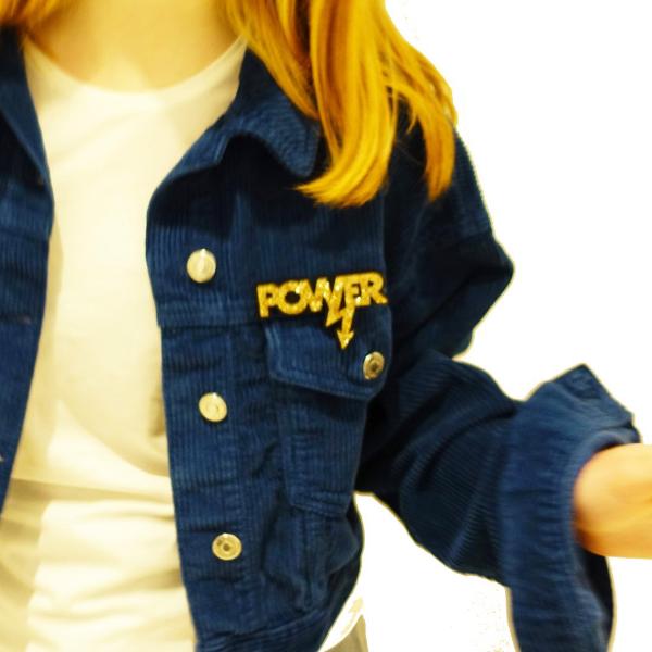 model wearing gold glitter Mary Beard power brooch