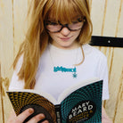 Eliza wears teal Girly swot necklace with hanging Lady Hale spider and reads Mary Beard's Women & Power. Girly swots unite!